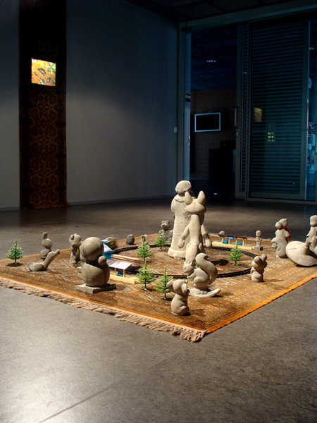 "The circle of the Past, Present and the Power". Installation: concrete, toys, carpet. behind: "My eastern journal". videoinstallation. 2010